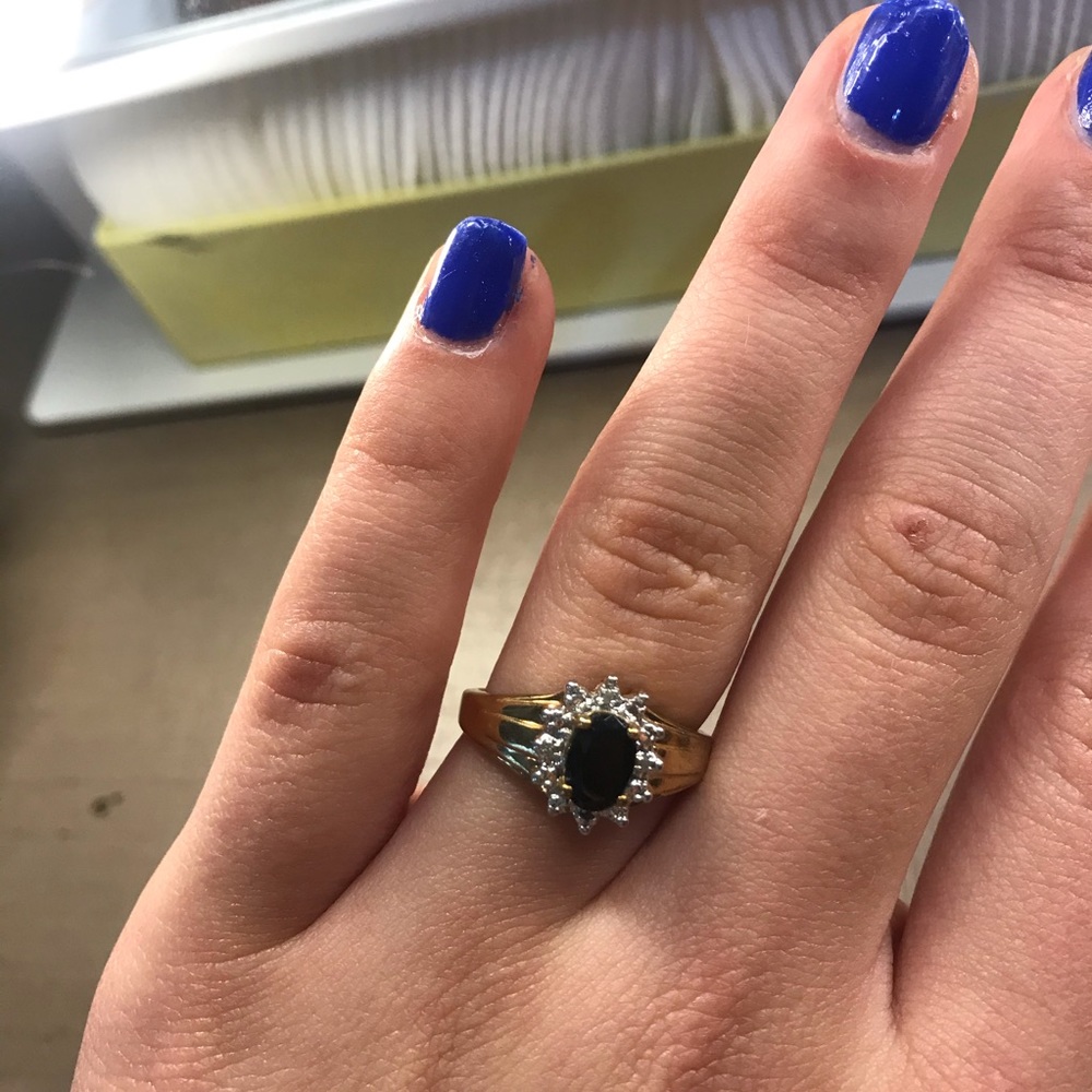 Gold ring with black jewel and diamonds